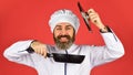 Ceramic applied pan. Preparing food in kitchen. Cooking food concept. High quality frying pan. Bearded man cook white Royalty Free Stock Photo