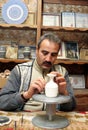 Ceramic artist drawing on traditional Turkish jug