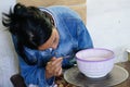 A ceramic artist paints a design on a bowl in Fez, Morocco .