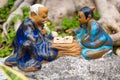 Ceramic asian men statuettes paying strategy game Go, an old traditional Chinese board game, Vietnam