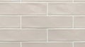 Ceramic beige tiles line horizontal brick background tile wall
