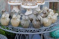 Ceramic birds and vintage rusty candlesticks stand on the openwork table