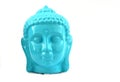 Ceramic Blue color Serene face statue of Buddha with flowers isolated on white background Royalty Free Stock Photo