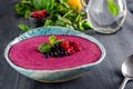 Ceramic bowl with berry smoothie decorated with currant, raspberry and mint on the black wooden background - Well being, Healthy e Royalty Free Stock Photo