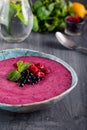 Ceramic bowl with berry smoothie decorated with currant, raspberry and mint on the black wooden background - Well being, Healthy e Royalty Free Stock Photo
