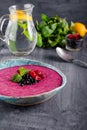 Ceramic bowl with berry smoothie decorated with currant, raspberry and mint on the black wooden background - Well being, Healthy e Royalty Free Stock Photo