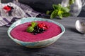 Ceramic bowl with berry smoothie decorated with currant, raspberry and mint on the black wooden background - Well being, Healthy e Royalty Free Stock Photo