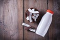 Ceramic bowl with coconut slices, coconut milk in bottle on a wooden background.Selective focus, copy space