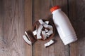 Ceramic bowl with coconut slices, coconut milk in bottle on a wooden background.Selective focus, copy space