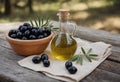 Ceramic bowl full of selected black olives and glass decanter of extra virgin olive oil stand on wooden table with rural Royalty Free Stock Photo