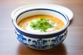 ceramic bowl of lentil soup with a dollop of cream