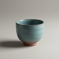 A ceramic bowl with a light blue glaze and earthy brown base. The bowl has a simple, Royalty Free Stock Photo