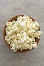 Ceramic bowl with popcorn on gray background