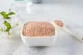 Ceramic bowl with red clay powder, for homemade facial and body mask or scrub and fresh sprig of flowering cherry Royalty Free Stock Photo