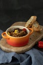 Ceramic bowl of spicy vegan chili con carne with seitan and kamut, beans, chili, peppers