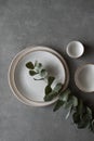 Ceramic bowls and plates on a dark background. Craft ceramic plates and bowls on a concrete table. Top view Royalty Free Stock Photo