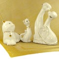 Ceramic cats and dogs, figurines standing on a napkin