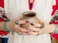 Jewelry, turquoise, precious stones. Pottery in female hands close-up