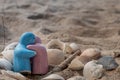 Ceramic couple dolls and shells in sand on the beach and copy space