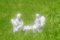 Ceramic couple having tea in a foggy garden