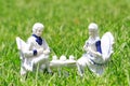 Ceramic couple having tea in a the garden