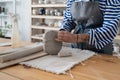 Woman professional ceramicist building pieces out of clay while working in her own pottery studio Royalty Free Stock Photo