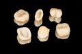 Ceramic crowns of human teeth closeup macro isolate on a black background. The concept of aesthetic dentistry Royalty Free Stock Photo