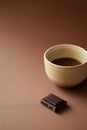 Ceramic cup of coffee with dark chocolate piece.- AI Generated Royalty Free Stock Photo