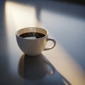 Ceramic cup filled with steaming black coffee sits on a smooth, Royalty Free Stock Photo