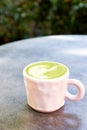 Ceramic cup of matcha latte on grey background