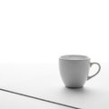 Ceramic cup with a simple, rounded design and a curved handle placed Royalty Free Stock Photo