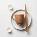 Ceramic cup with a textured surface sits on a white plate, accompanied b Royalty Free Stock Photo
