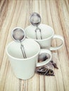 Ceramic cups with tea strainers and tea bags Royalty Free Stock Photo
