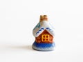 Ceramic decor, fairy Christmas toy house in snow isolated on white background. Royalty Free Stock Photo