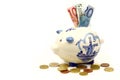 Ceramic Delft Blue piggy bank with euro paper money Royalty Free Stock Photo
