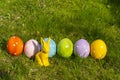 Ceramic easter eggs and an Easter bunny in a line on a meadow Royalty Free Stock Photo