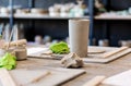 Ceramic equipment and a raw clay vase on a wooden table in a workshop Royalty Free Stock Photo