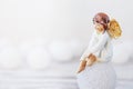 Ceramic figure of angel on light background. Copy spase Royalty Free Stock Photo