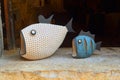 Ceramic Fish on Stone Shelf dark backgrond.