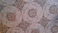 ceramic floor background texture with a reddish brown circular mosaic motif Royalty Free Stock Photo