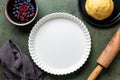 Ceramic form, pan for Cooking mixed berry crust pie or tart, mini tarts. Raw dough Royalty Free Stock Photo