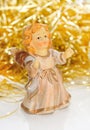 Ceramic girl-angel with golden tinsel . Royalty Free Stock Photo