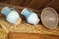 Ceramic glazed blue jugs and traditional clay bowl on wooden background