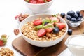 Ceramic granola bowl, assorted ingredients on table. Healthy nutritious breakfast with vegan yogurt, raw fruits, nuts and cereals. Royalty Free Stock Photo