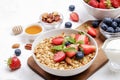 Ceramic granola bowl, assorted ingredients on table. Healthy nutritious breakfast with vegan yogurt, raw fruits, nuts and cereals. Royalty Free Stock Photo