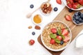 Ceramic granola bowl, assorted ingredients on table. Healthy nutritious breakfast with vegan yogurt, raw fruits, nuts and cereals. Royalty Free Stock Photo