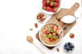 Ceramic granola bowl, assorted ingredients on table. Healthy nutritious breakfast with vegan yogurt, raw fruits, nuts and cereals. Royalty Free Stock Photo