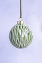 Ceramic Green Christmas Bauble on a light background. Royalty Free Stock Photo