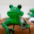 Ceramic green frog in a frivolous pose Royalty Free Stock Photo