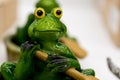 Ceramic green frog in a frivolous pose Royalty Free Stock Photo